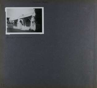 1 photo with view of single storey white building with arched doorway entrance.  Other buildings may join up to it. 