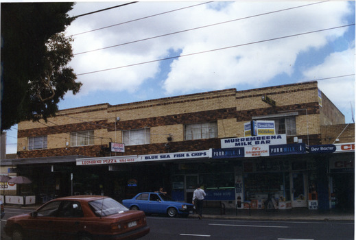 Set of 5 two storey matching brick shops from across the road