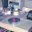 Kitchen table with toaster, delivered meal in round aluminium container with an apple on top.