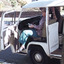 Open doored delivery van with a female passenger carrying a meal.
