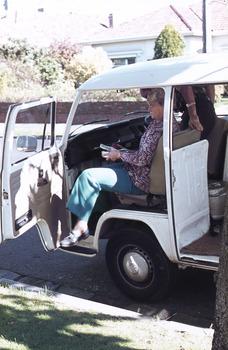 Open doored delivery van with a female passenger carrying a meal.
