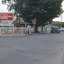 A man closing gates at a railway crossing.