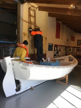 This timber workboat is the original one used to transfer pilots between the Pilot Ship Wyuna and ship requiring service. It is shown in a display arrangement at the QMM.