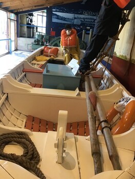 An inside view of the boat showing accessories and oars.