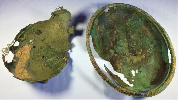 Oval Tray which is badly tarnished through and badly damaged in various areas. Contains green corrosion layers and some encrustation.
