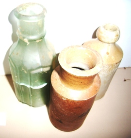 Three bottles, One ceramic bottle   G. James  Brighton