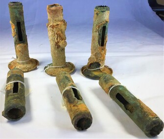 Six candle stems, 3 with base plate and three without, showing corrosion and encrustation