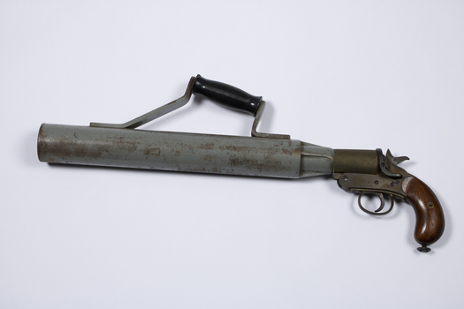 A pistol with a large barrel to enable a line throwing rocket to be launched. It has an extra handle for stability during firing.