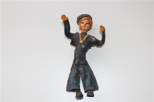 Felt doll of a female sailor in a blue uniform and cap