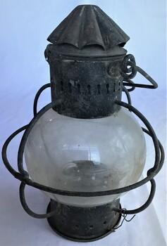 A metal lamp with glass globe