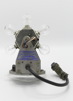 An electrical device with a rotating lamp holder containing 6 light globes attached to a motor with an electrical lead attached to an industrial pin socket.