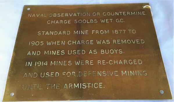 Brass plaque inscribed with information regarding mines.