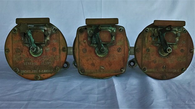 Three switches (General, unknown and collision alarm) on a metal frame from the HMAS Canberra prior to her scuttling on October 2009  