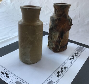 Two earthenware containers one with encrustation and concretion  