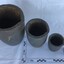 Four carbon crucibles of diminishing sizes used on board ship to melt lead and other repair metals.