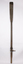 A timber oar with fitted metal rowlocks which has a lower metal strap across the blade attached. The top strap is missing.