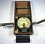 Round instrument for measuring ships' heeling error, in wooden box and a metal case containing an adjusting tool. 