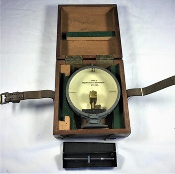 Round instrument for measuring ships' heeling error, in wooden box and a metal case containing an adjusting tool. 