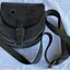 Top view of leather pouch with clasping buckle and shoulder strap.