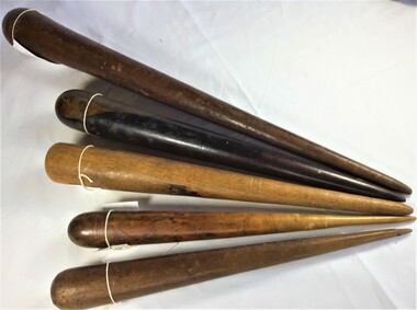 Five fids made of timber. A fid is a conical tool made of wood or bone used to work with rope and canvas in sail making or for splicing rope.