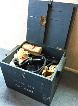 Timber box containing hand lamp [Aldis lamp], resister with cable, switch and plug [lamp was converted to 240v power], envelope containing screen and 5 Mazda light globes. 