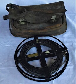 Survey metal tape on reel with leather bag. 10 yards in length, the metal chain is subdivided every 10 links [2.2 yards].