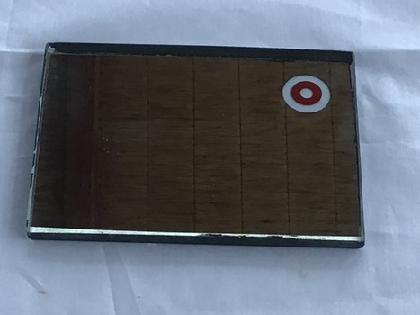 A small reflection mirror with a circular clear sight hole on the top right hand side, which enables accurate direction of reflector to potential rescue source. 