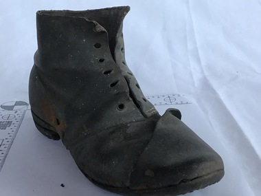 A child's well worn black boot found under the floor of a pilot's terrace house in Gellibrand Street Queenscliff. It is over 170 years old and was probably put there by the family during construction for good luck or to ward off bad luck