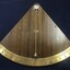 Inclinometer from the M.V. Australian Explorer. A triangular shaped inclinometer with curved base. Brass measuring plate with measurements from 0-40 degrees on each side. Brass pointer indicates angle of inclination of vessel.