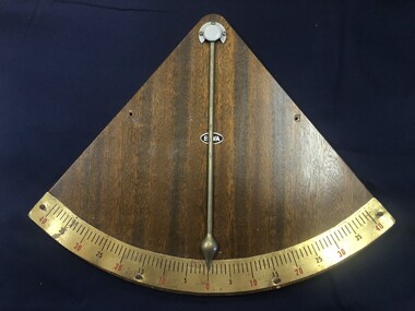 Inclinometer from the M.V. Australian Explorer. A triangular shaped inclinometer with curved base. Brass measuring plate with measurements from 0-40 degrees on each side. Brass pointer indicates angle of inclination of vessel.