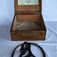 Two photographs showing the azimuth mirror circle and the timber box it is stored in. The box has instructions on the inside of the lid.