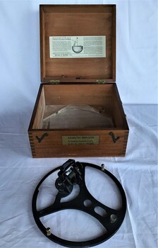 Two photographs showing the azimuth mirror circle and the timber box it is stored in. The box has instructions on the inside of the lid.