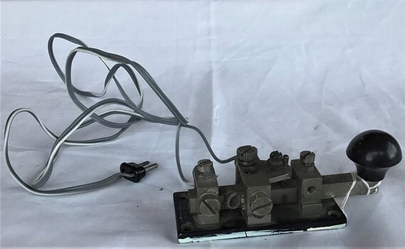 Side view showing a morse key and cable from the 1940s.