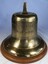 A brass ship's bell from the MV Townsville Trader mounted on a timber base.