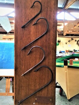  A selection of four home made shark hooks of various sizes