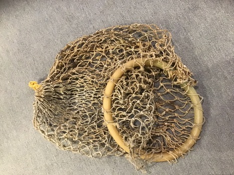 Round shaped length of hose covering a ring of wire onto which a hemp net is woven. The net is tied closed at the bottom end to hold caught fish.