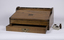 A mahogany lap writing desk with roll top lid shown in the closed position and an open drawer.