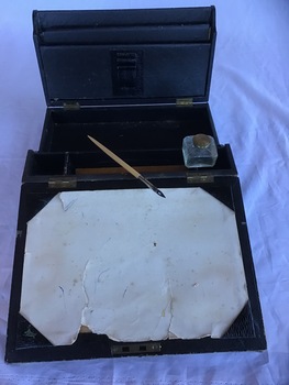 Black portable writing desk with brass handle; open view 