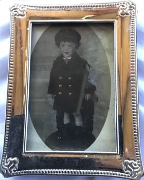 Silver frame containing photograph of a young boy