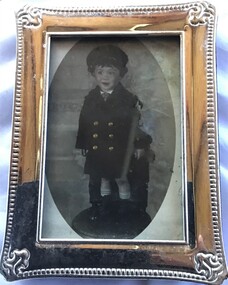 Silver frame containing photograph of a young boy