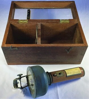A Sestrel hand held bearing compass with wooden handle in own glass fronted, wooden container.