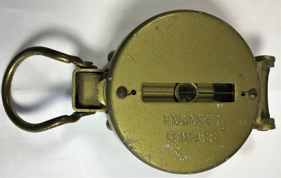 A small hand held engineer compass shown in the closed position.