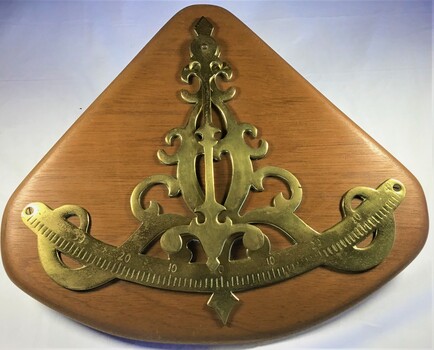 Brass inclinometer mounted on a timber base