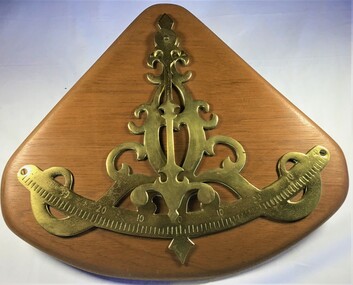 Brass inclinometer mounted on a timber base