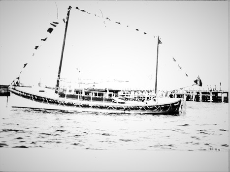 Photo of the Lifeboat "Queenscliffe", moored, with flags flying, Watson type cabin motor lifeboat by McFarlane Adelaide in 1925.