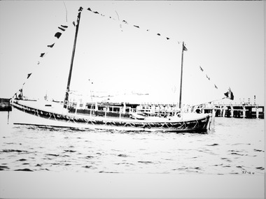 Photo of the Lifeboat "Queenscliffe", moored, with flags flying, Watson type cabin motor lifeboat by McFarlane Adelaide in 1925.
