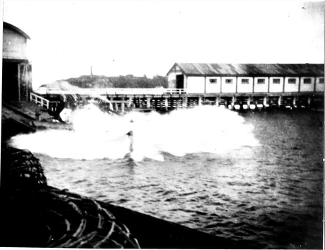 Black & white photograph of the lifeboat QUEENSCLIFFE launching showing old pier