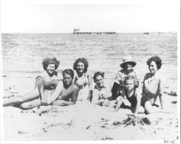 black & white photo that includes old piers, breakwaters and a family picnic
