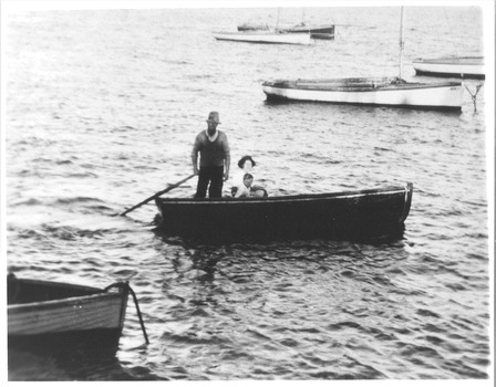 black & white photographs of a family in a sculling dinghy