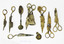 A collection of complete and remnant pieced of candle wick trimmers most heavily encrusted.